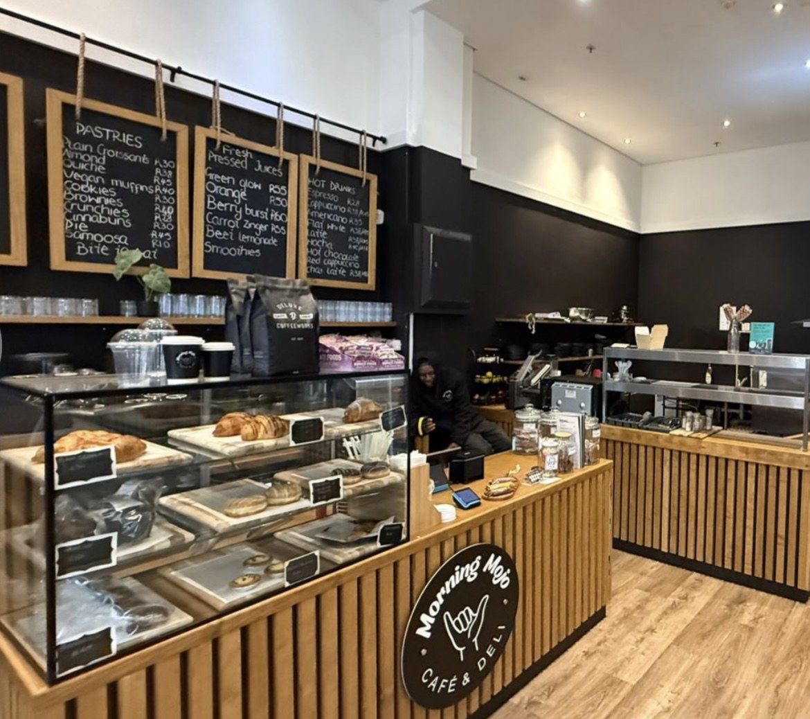 Morning Mojo Café and Deli counter with pastries and oak panelling