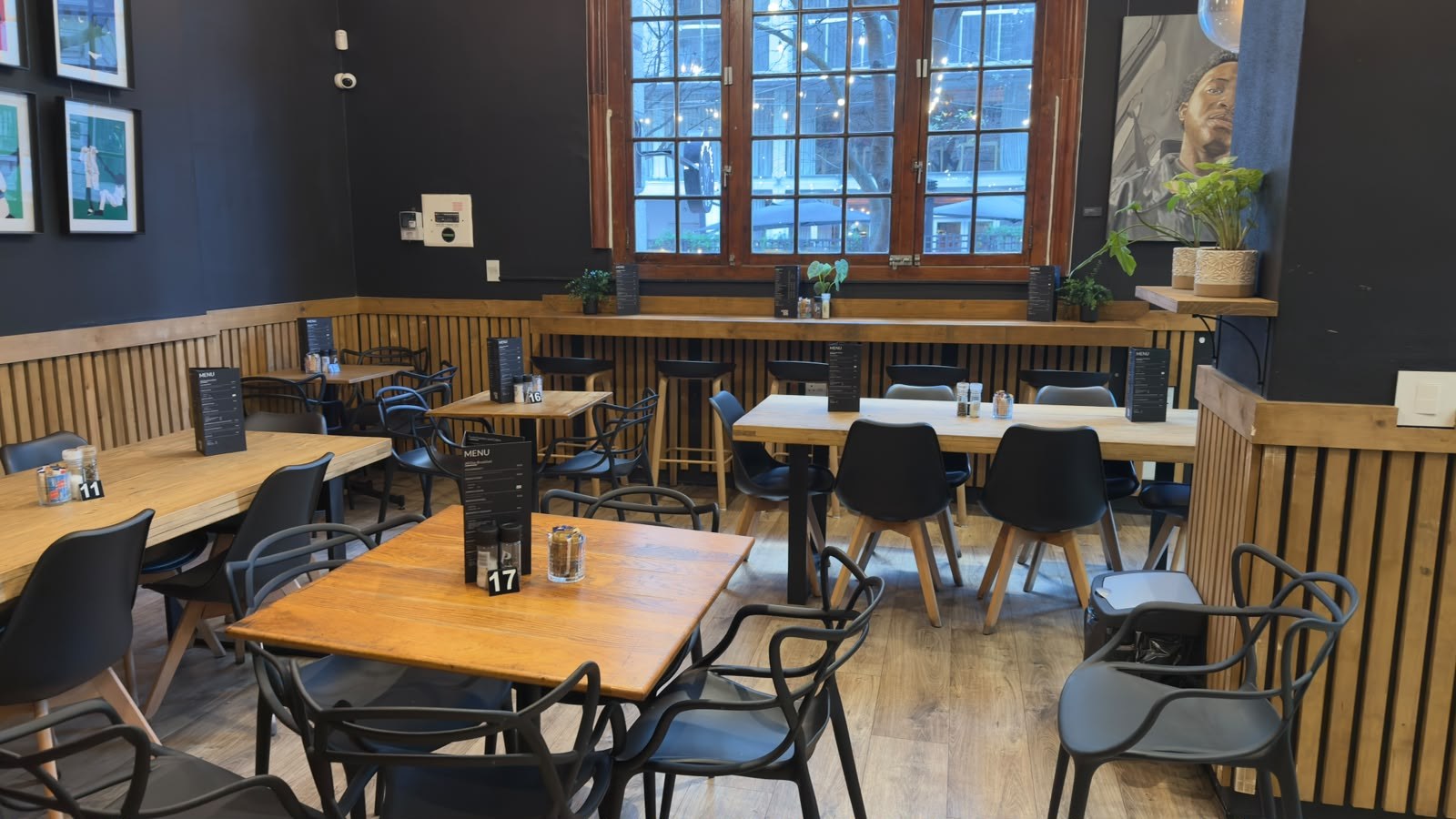 Oak tables and black chairs in the café dining room